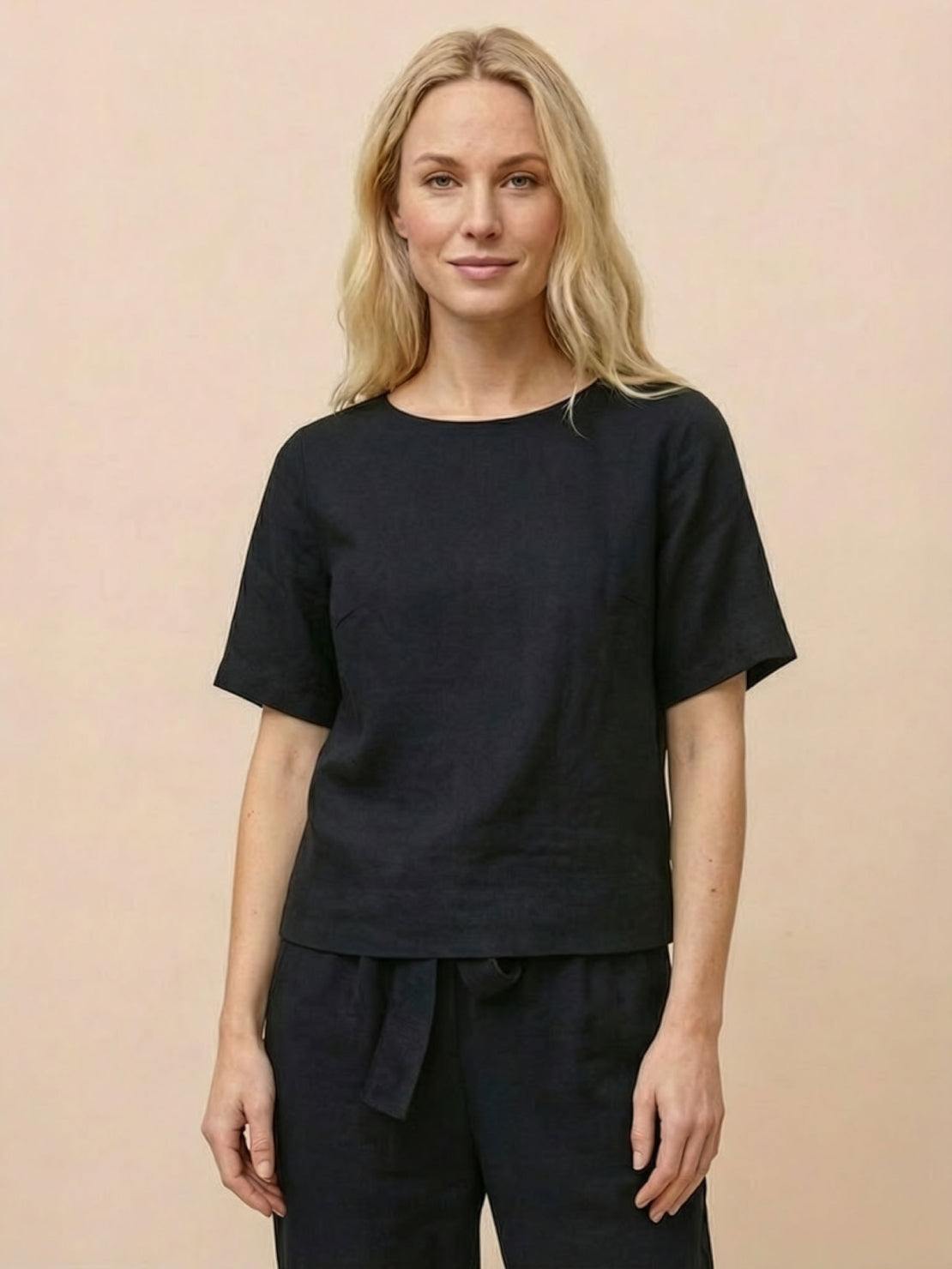 Woman wearing relaxed monochrome cotton linen set with short-sleeve top and straight-leg pants