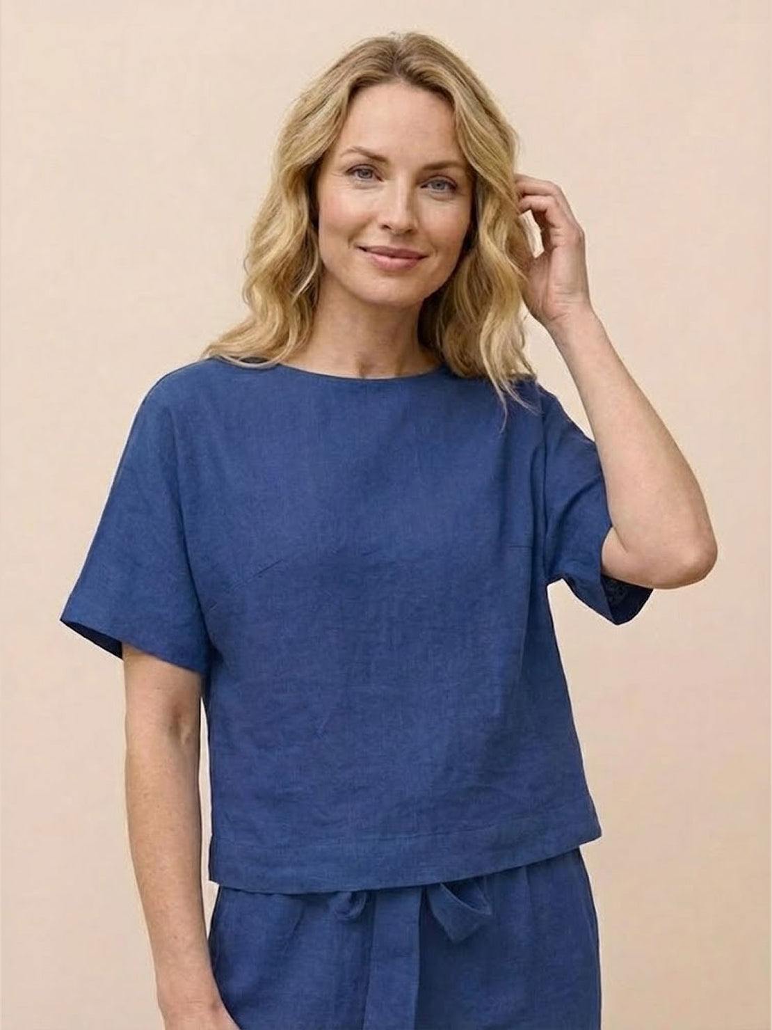 Woman wearing relaxed cotton linen set with short sleeve top and straight-leg pants in monochrome tones