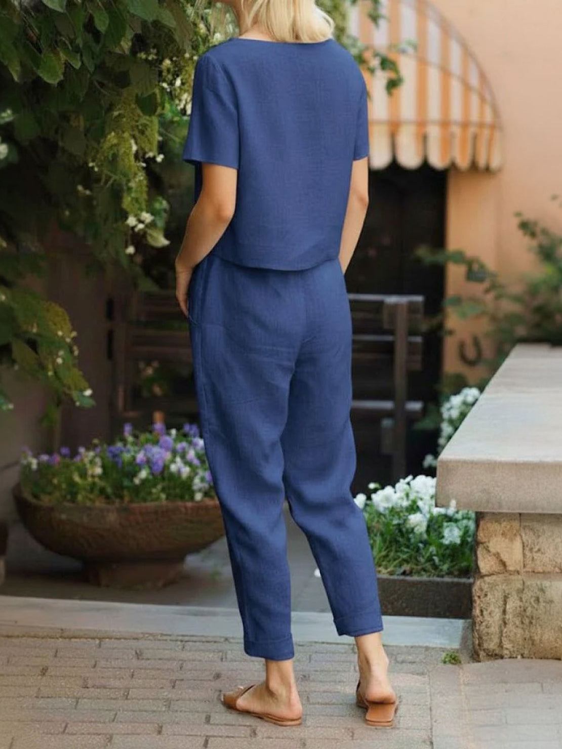 Woman wearing relaxed cotton linen set with short-sleeve top and straight-leg pants in monochrome tones