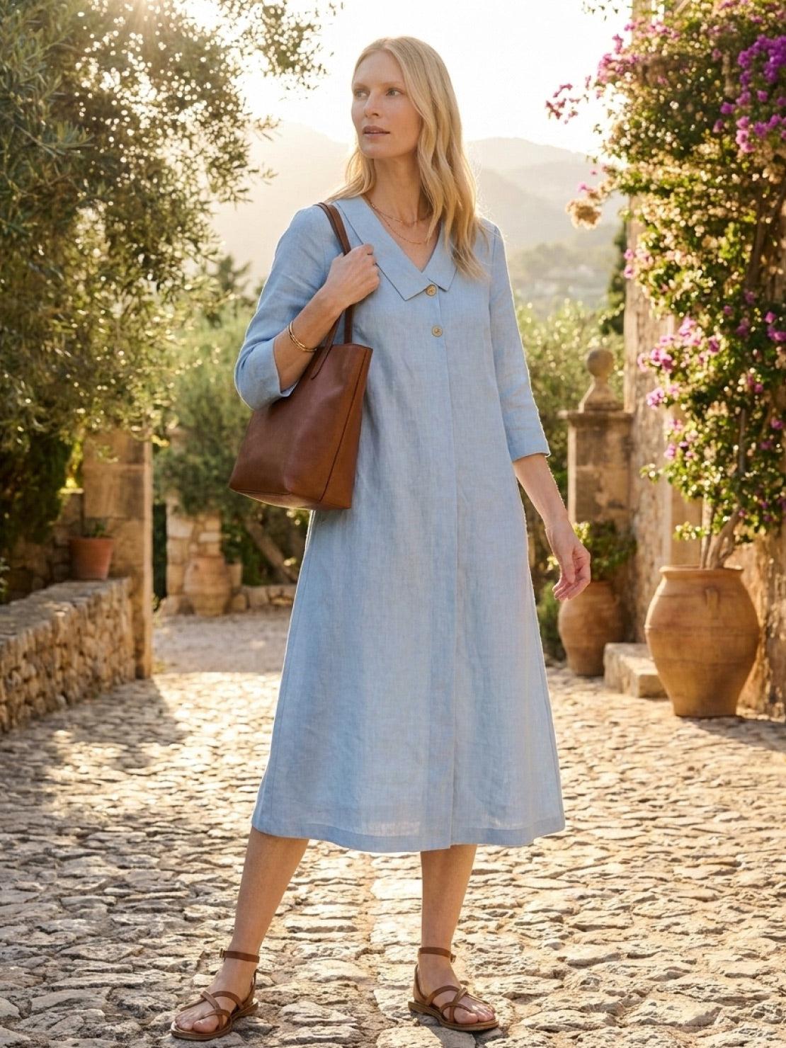 woman wearing navy linen-look midi dress with blazer neckline and side pockets