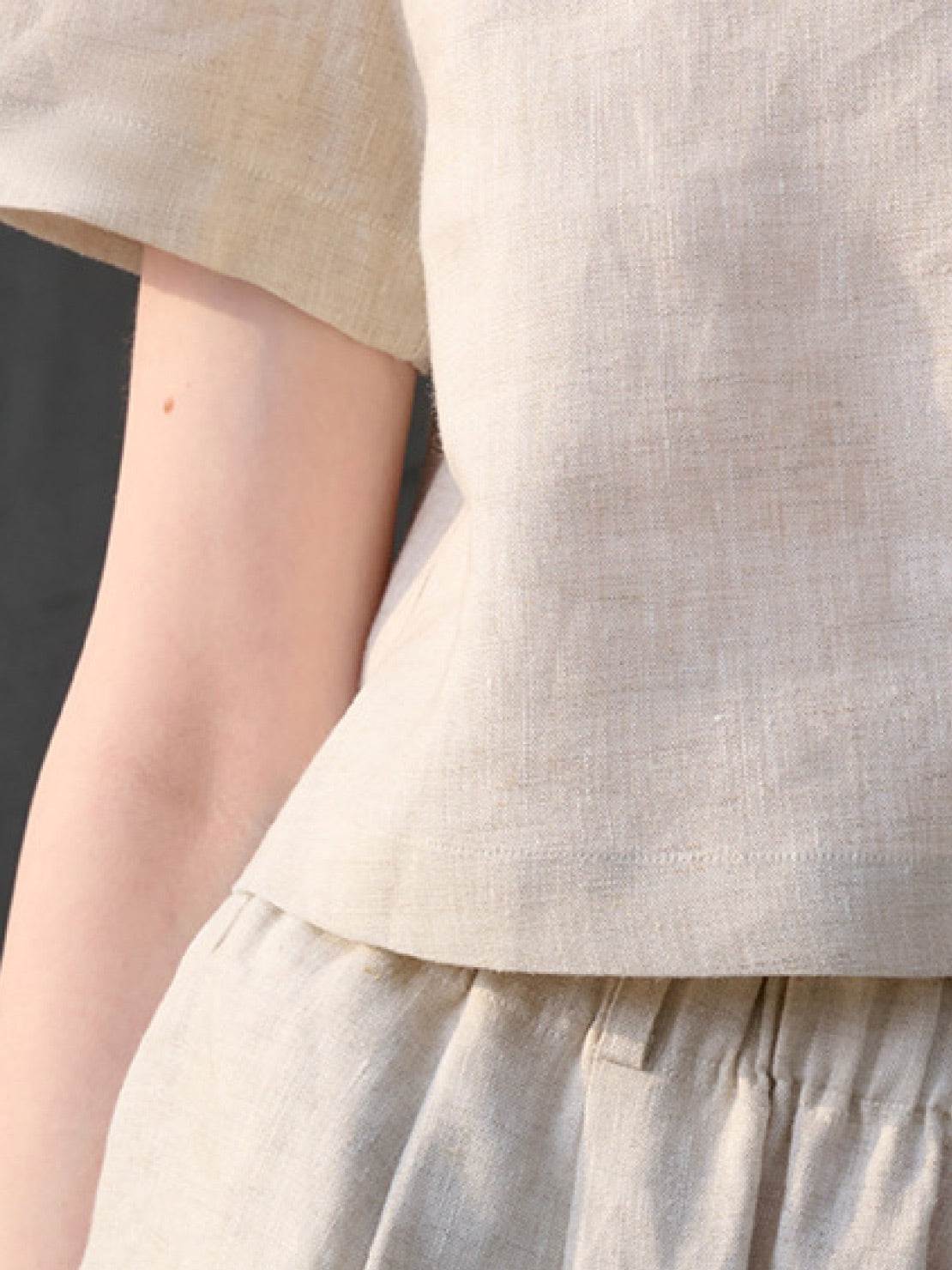 Lightweight 100% linen French top with V-neck, short sleeves, and three-button front detail in relaxed boxy shape