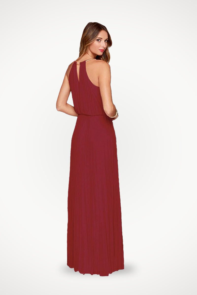 Woman wearing sleeveless belted maxi pleated dress in red wine color, showing back view.