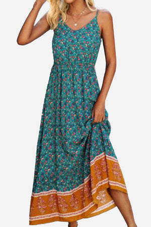 Woman wearing a vintage flower prints maxi dress with spaghetti straps and elastic waist