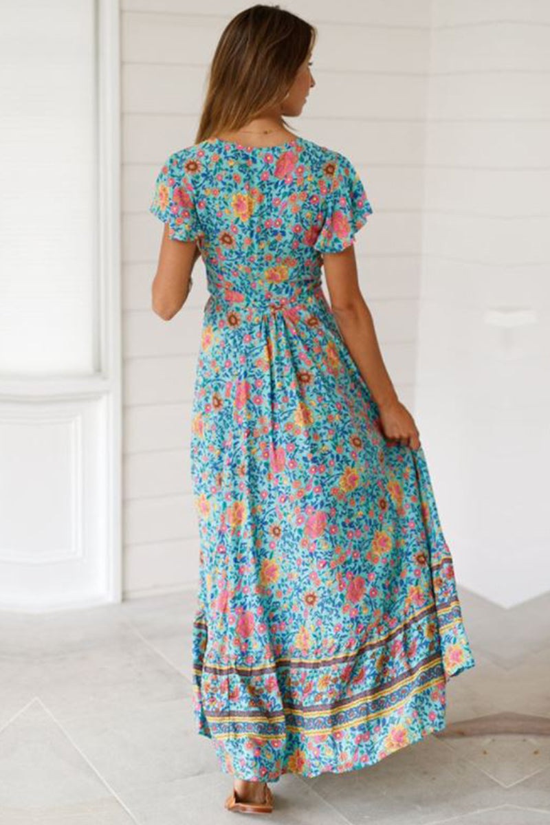 Woman wearing a Bohemian floral print wrap dress with short sleeves and ruffle skirt, shown from the back