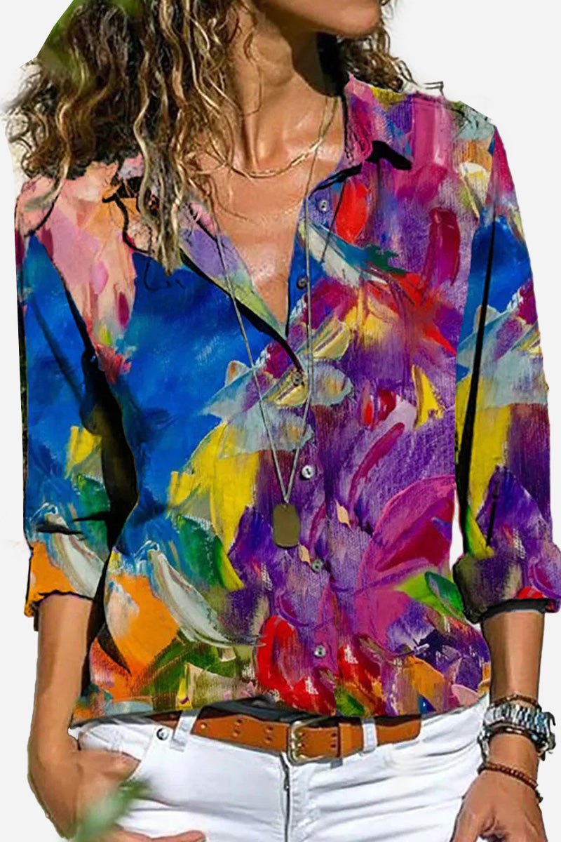 Women wearing a colorful long-sleeved casual printed loose shirt with abstract floral design and white pants