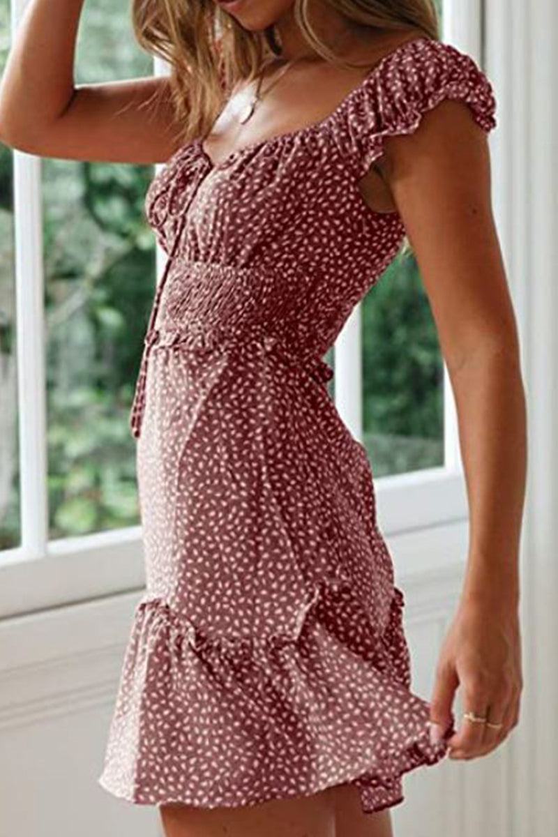 Woman wearing a maroon sweetheart collar printed ruffled maxi dress with a high waist design and soft material.