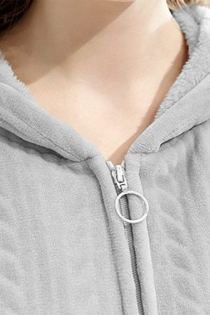 Close-up of stylish flannel nightgown zipper and soft hood collar in light grey fabric