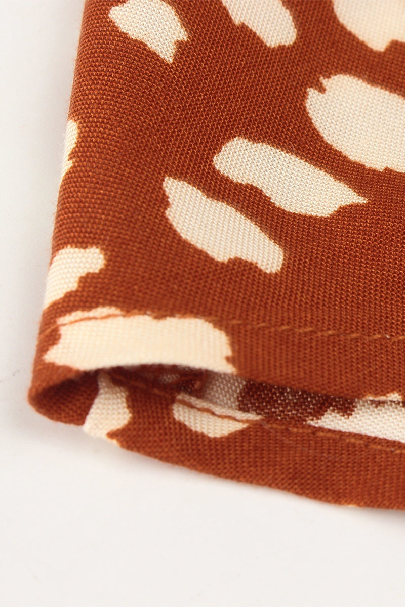 Close-up of casual bohemian dress skirt fabric with brown and cream boho dot print and soft polyester material.
