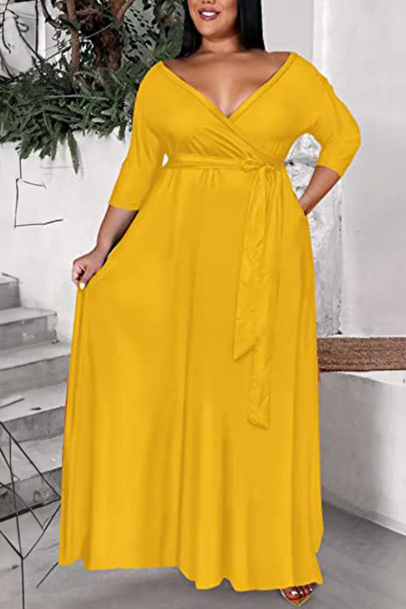 Plus size yellow dress with deep V-neck, tie belt, and 3/4 sleeves in soft fabric