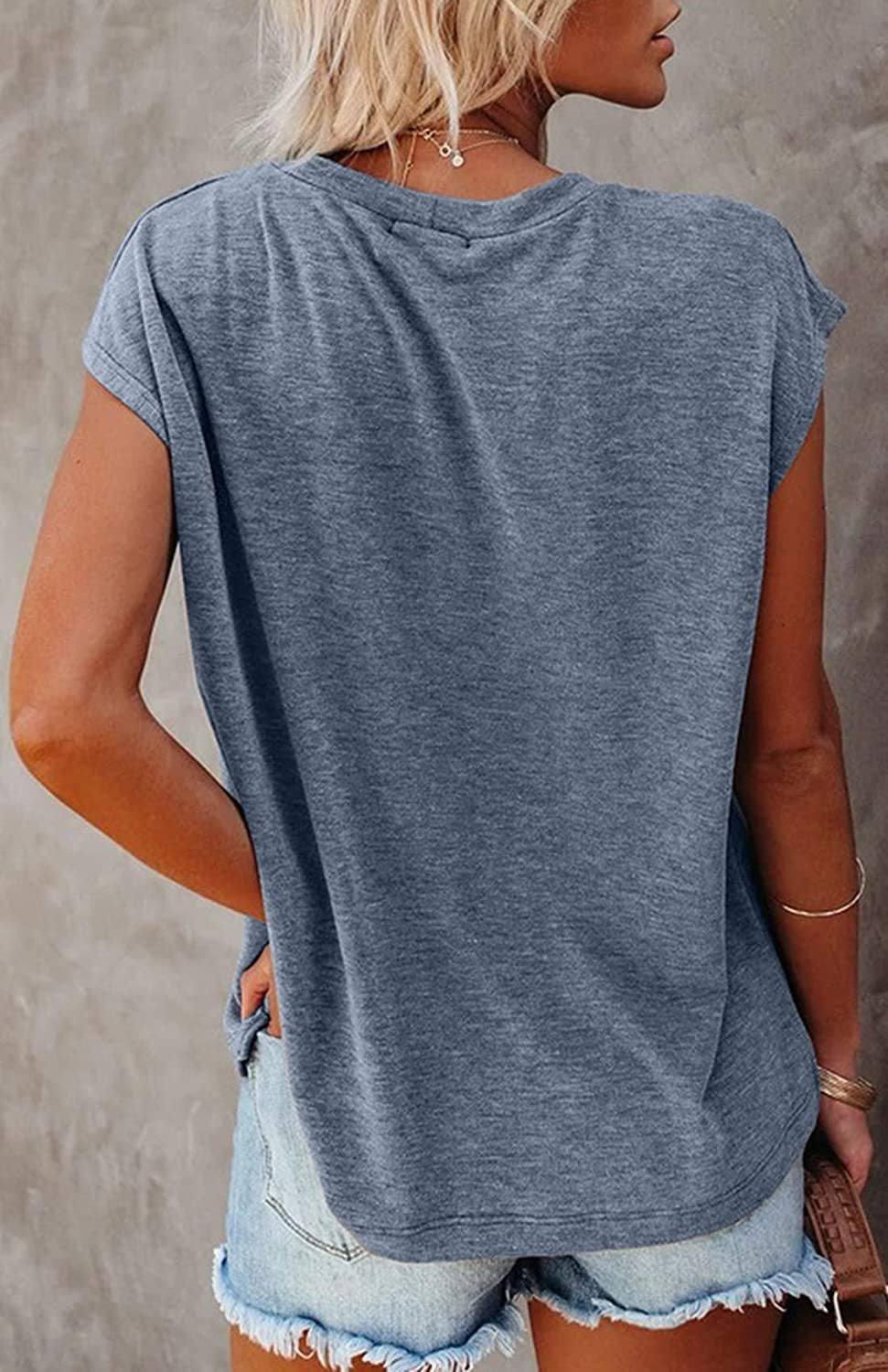 Back view of a woman wearing a lightweight, breathable Easy Breezy Tunic Shirt in heather gray with cap sleeves, paired with denim shorts.