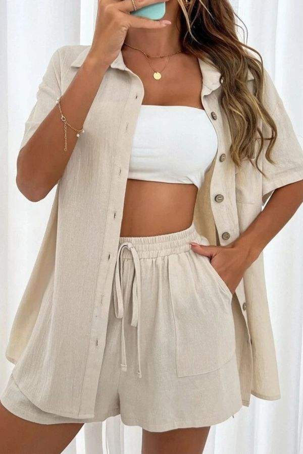Woman wearing beige Sunny Day Vibrance two-piece set with shorts and button-up shirt over white tube top