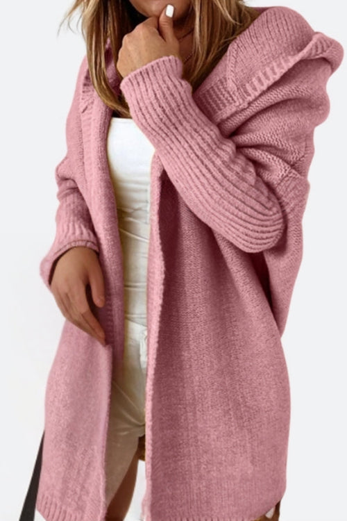 Pink warm oversized hooded cardigan with ribbed sleeves and relaxed fit on a model