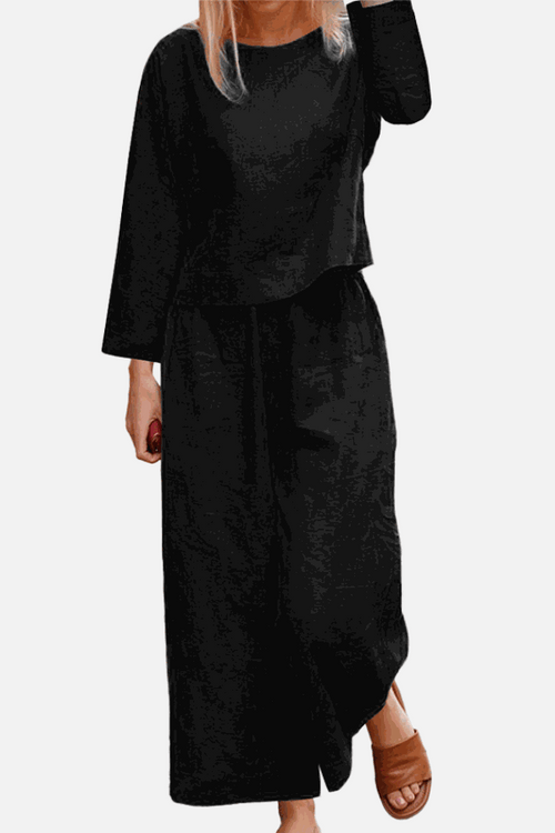 Loose solid color two-piece set with long sleeves and wide-leg pants in black breathable fabric.
