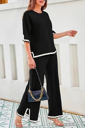 Black short sleeved relaxed fit lounge two-piece set with white trim and wide-leg palazzo pants.