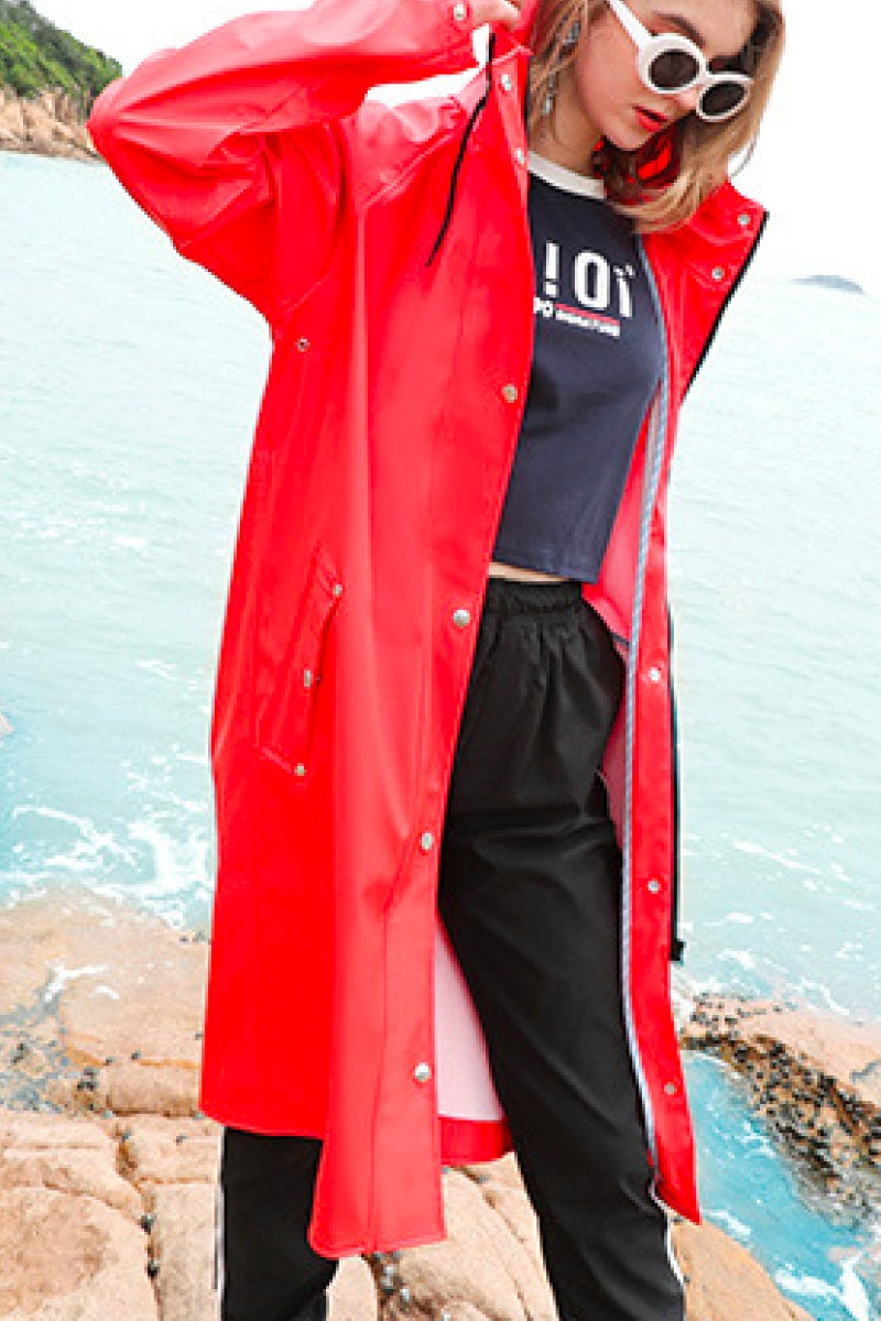 Lightweight ultra water-resistant long red windbreaker jacket with hood, button and zipper closure, designed for rain and wind protection during outdoor activities.