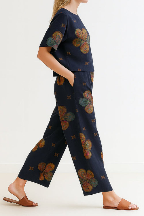 Woman wearing navy floral loose fit co-ord set with wide-leg pants and short-sleeve top