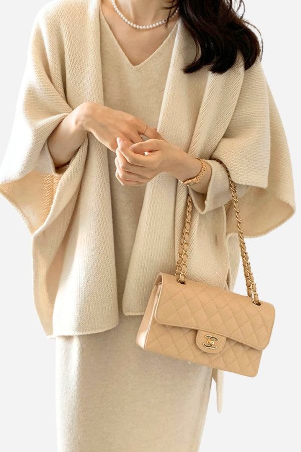 Relaxed flowy open front knitwear cardigan in beige with a loose fit, styled with a matching dress and tan quilted handbag.