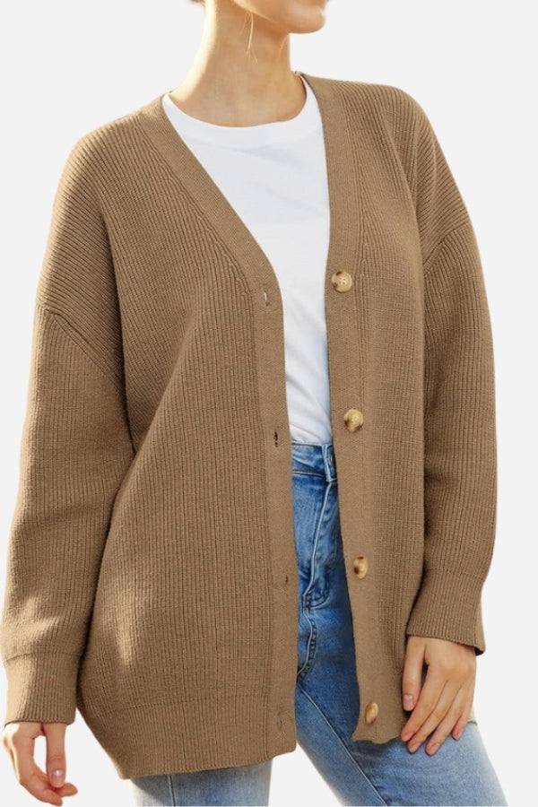Relaxed fit oversized brown knit cardigan with button down front worn over white shirt and jeans