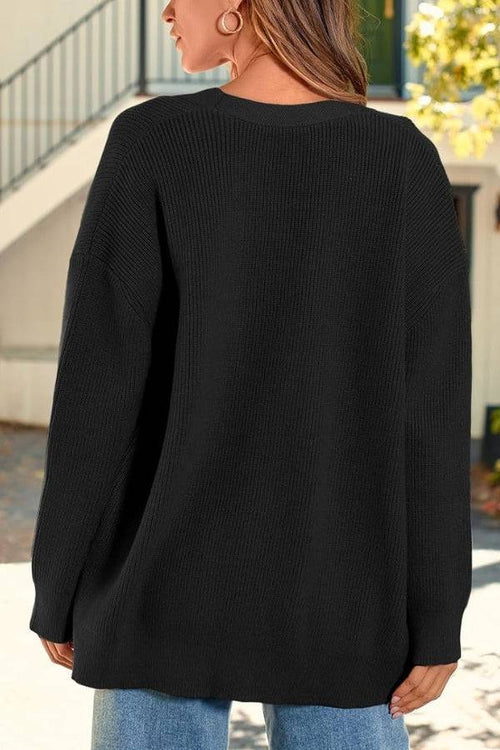Relaxed fit oversized black knitwear cardigan with long sleeves and lightweight cozy fabric.