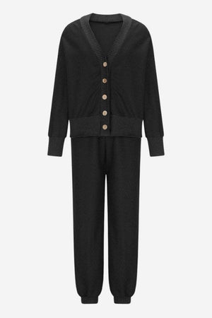 Black two-piece knitwear set with buttoned cardigan and relaxed pants, soft polyester fabric, comfortable and versatile design.