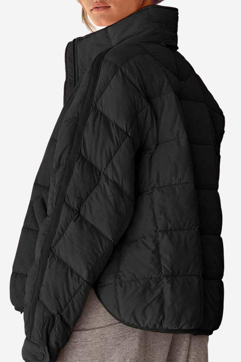 black lightweight puffer travel jacket with quilted design and high collar