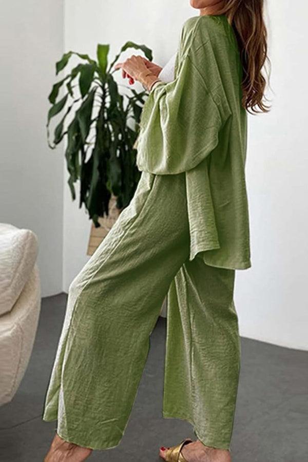 Woman wearing olive green Chic Comfort Kimono two-piece lounge set with loose fit and wide-leg pants indoors
