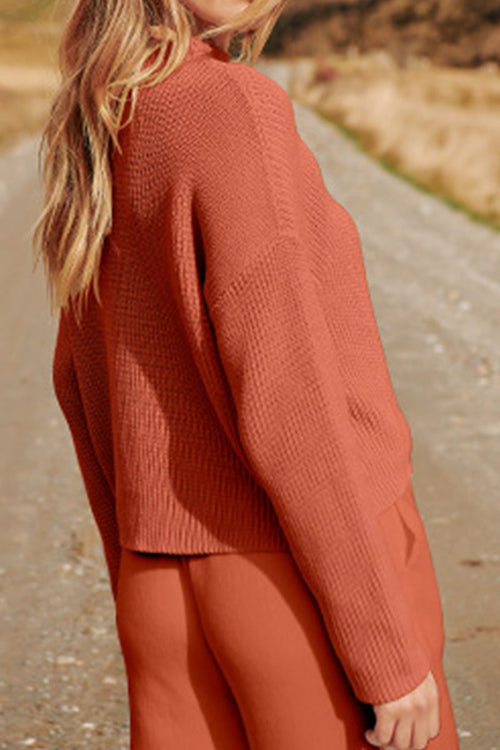 Woman wearing relaxed knit sweater top and trouser set in earthy tones inspired by European Minimalism on outdoor path