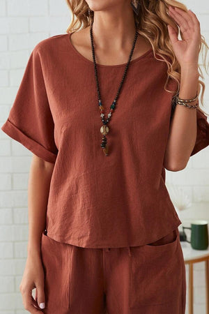 Women's rolled cuff top and patch pocket pants set in rust color, relaxed fit, breathable cotton blend fabric.
