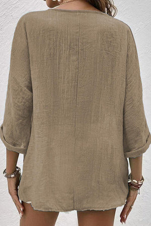 Back view of beige artisanal crinkle fabric button front tunic with rolled sleeves