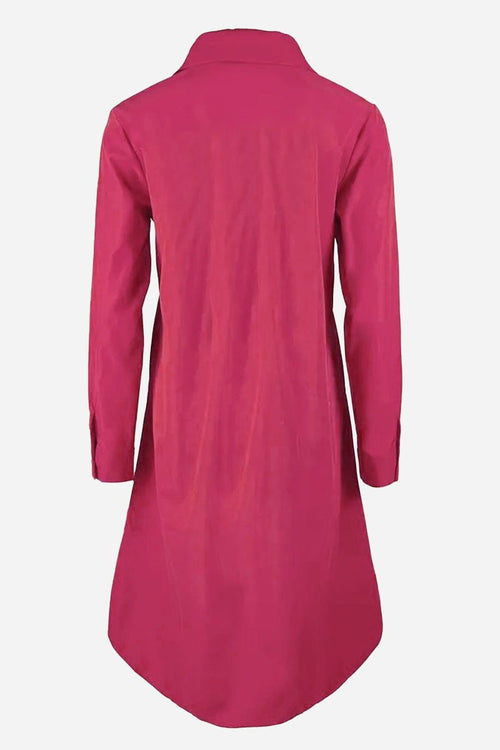 Back view of a vibrant pink long shirt-style dress with long sleeves and collar on plain background