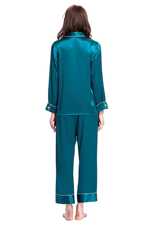 Back view of teal long sleeve silk pajamas set with button-up top and full-length pants on model