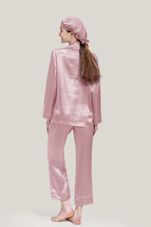 Back view of woman wearing pink Mulberry silk pajama set with matching sleep cap