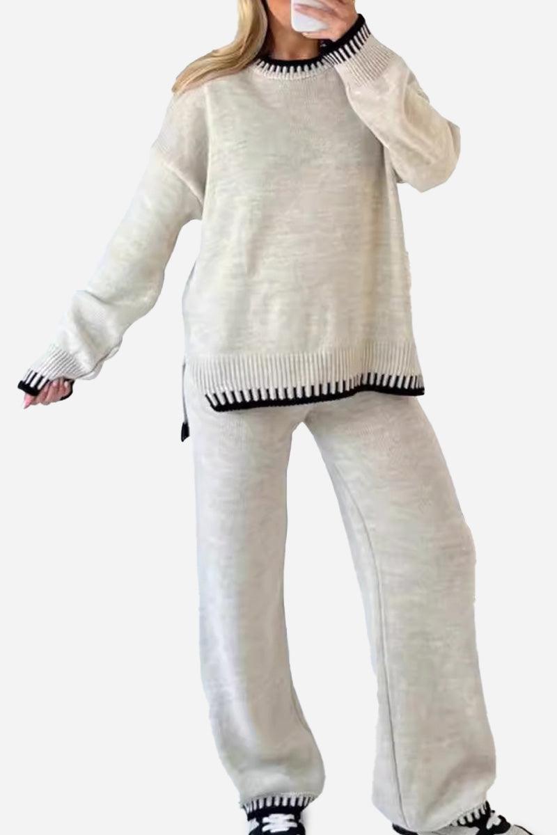Woman wearing chic contrast stitch travel set with relaxed fit sweater and pants