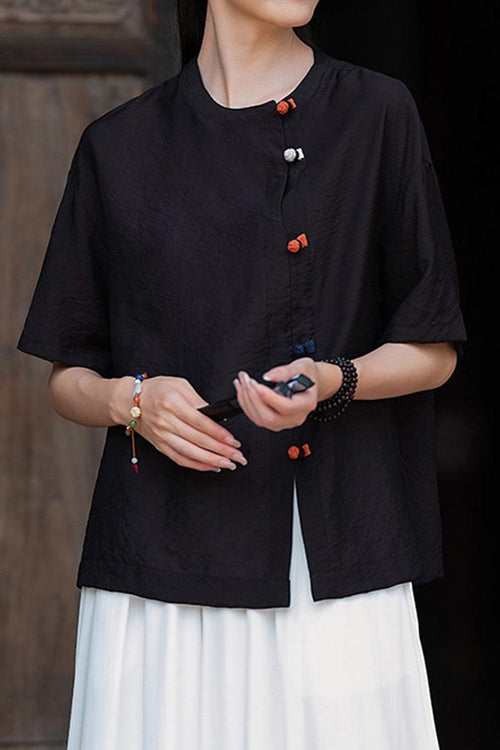 Black regenerated cellulose blouse with asymmetrical buttons and relaxed fit on model