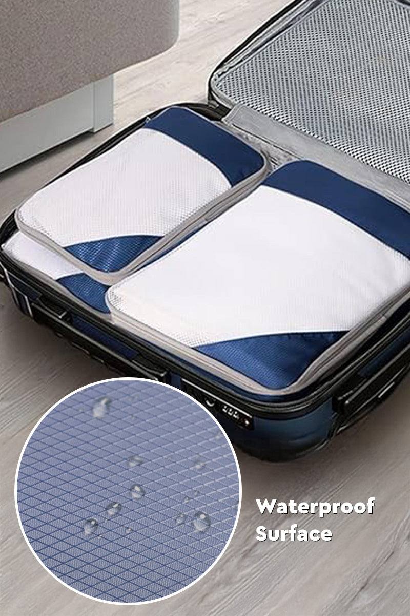 Space-saving compression packing organizers set with waterproof surface in open suitcase for efficient travel packing