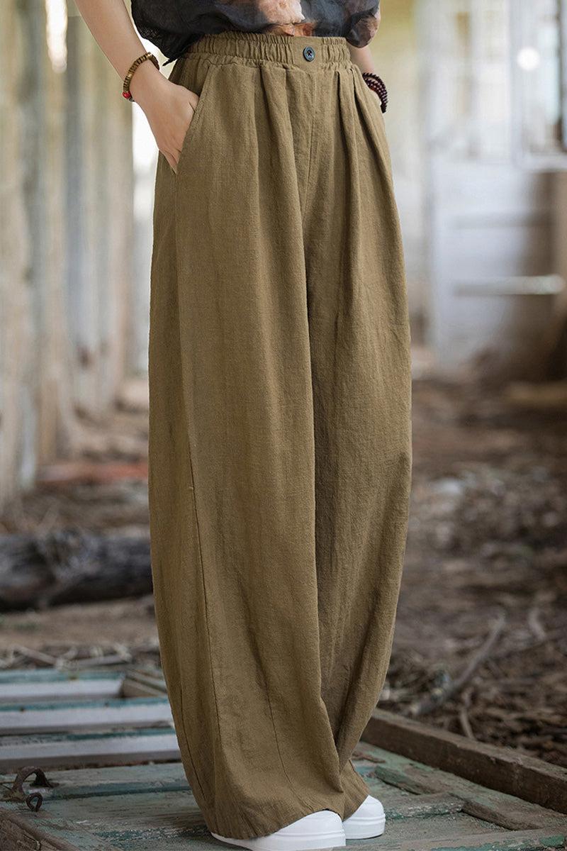 Relaxed fit sandwashed ramie linen pants with plush lining in olive green color worn with white sneakers.