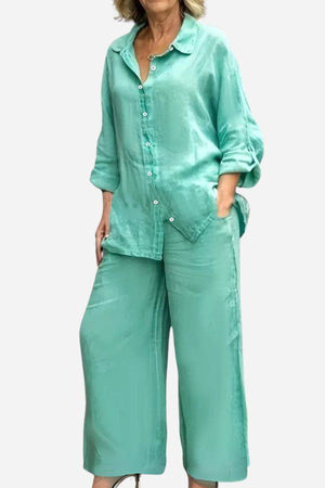 Woman wearing mint green cotton blend two-piece set with slub texture, featuring long-sleeve button-up top and wide-leg pants.