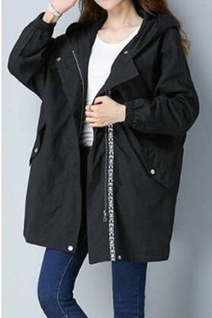 Black fashion hooded trench coat with oversized silhouette, mid-length design, and casual-cool style for travel and layering.