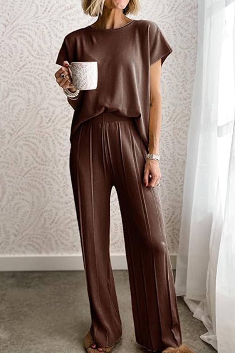 First Class Travel two-piece brown pleated loungewear set with wide-leg pants and short sleeve top for comfortable, wrinkle-resistant travel style