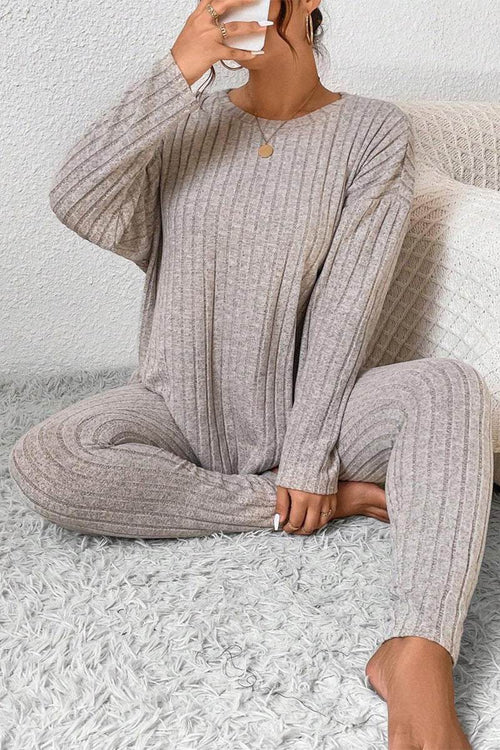 Woman wearing beige Body Confident Oversized Knit two-piece loungewear set sitting on carpet