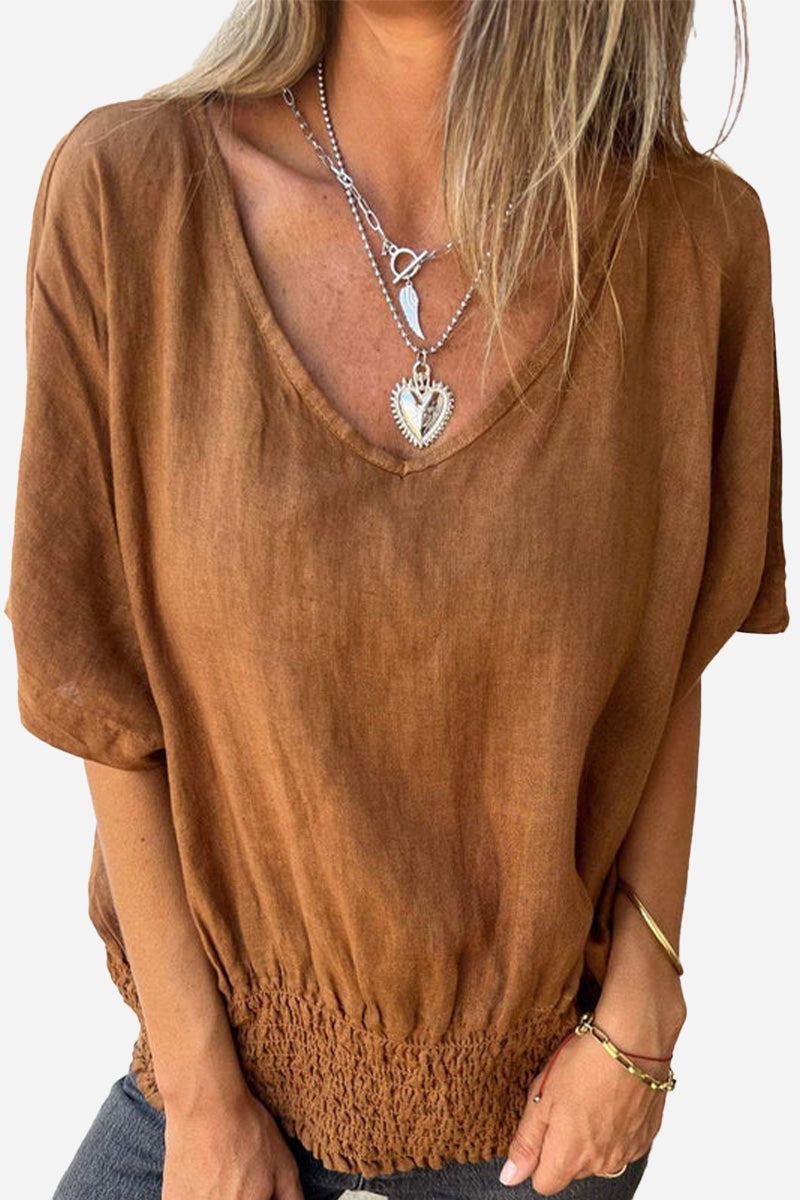 brown pure linen short sleeve blouse with v-neck and smocked hem worn with layered necklaces