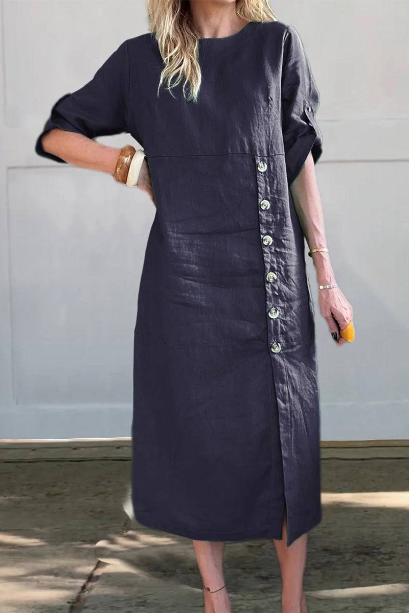 Woman wearing a navy Pure Cotton Elegance dress with side buttons and three-quarter sleeves