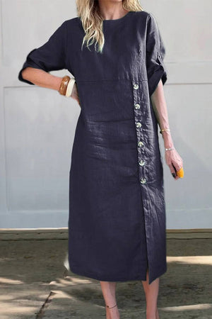 Woman wearing a navy Pure Cotton Elegance dress with side buttons and three-quarter sleeves