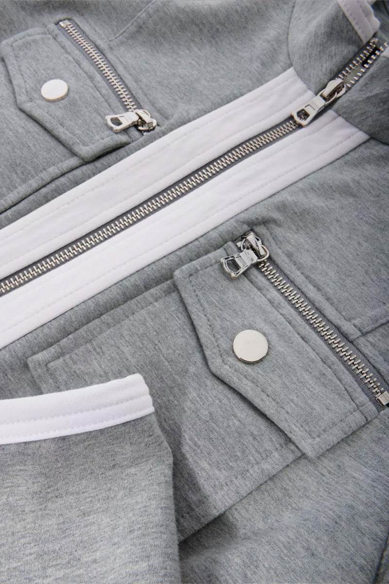 Close-up of grey Contrast Zip Two-Piece featuring contrasting white zipper and pockets with silver snap buttons.