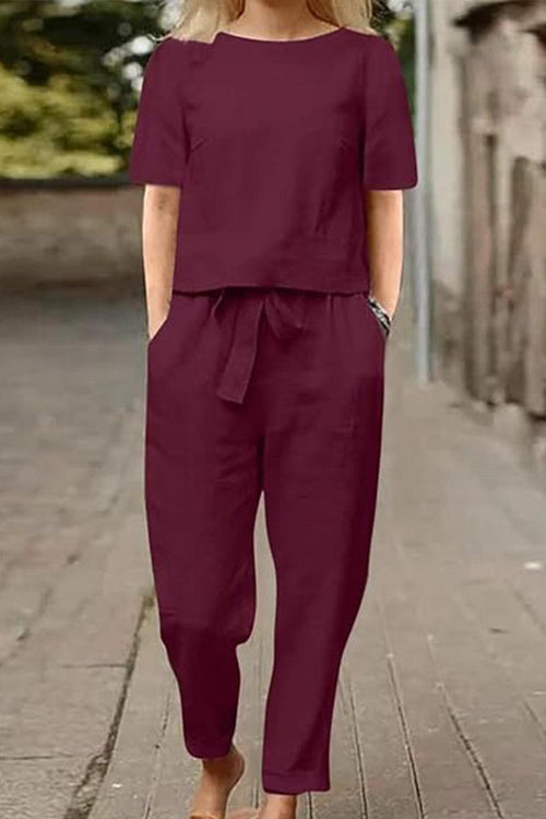 Woman wearing maroon cotton-linen blend monochrome two-piece set with short sleeves and drawstring pants outdoors