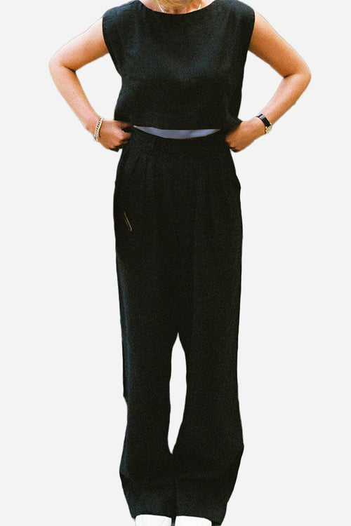 Woman wearing black cotton-linen blend sleeveless crop top and wide-leg pants two-piece summer outfit