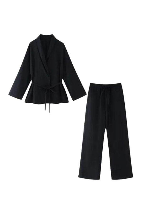 Black mix-match lounge-to-travel set with wide-leg pants and belted draped top in premium polyester