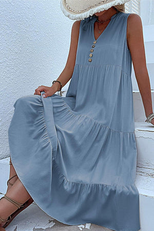 Bohemian tiered midi dress in blue with V-neck and button details, sleeveless and flowy summer dress.