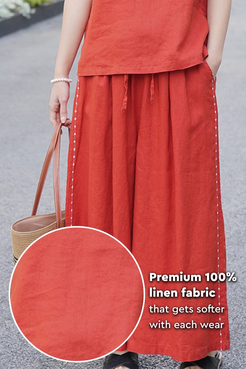 Woman wearing premium 100% linen wide-leg pants in burnt orange with elastic waist and side stitching detail