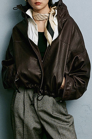 Dark brown genuine sheepskin leather jacket with glossy finish and relaxed fit on model